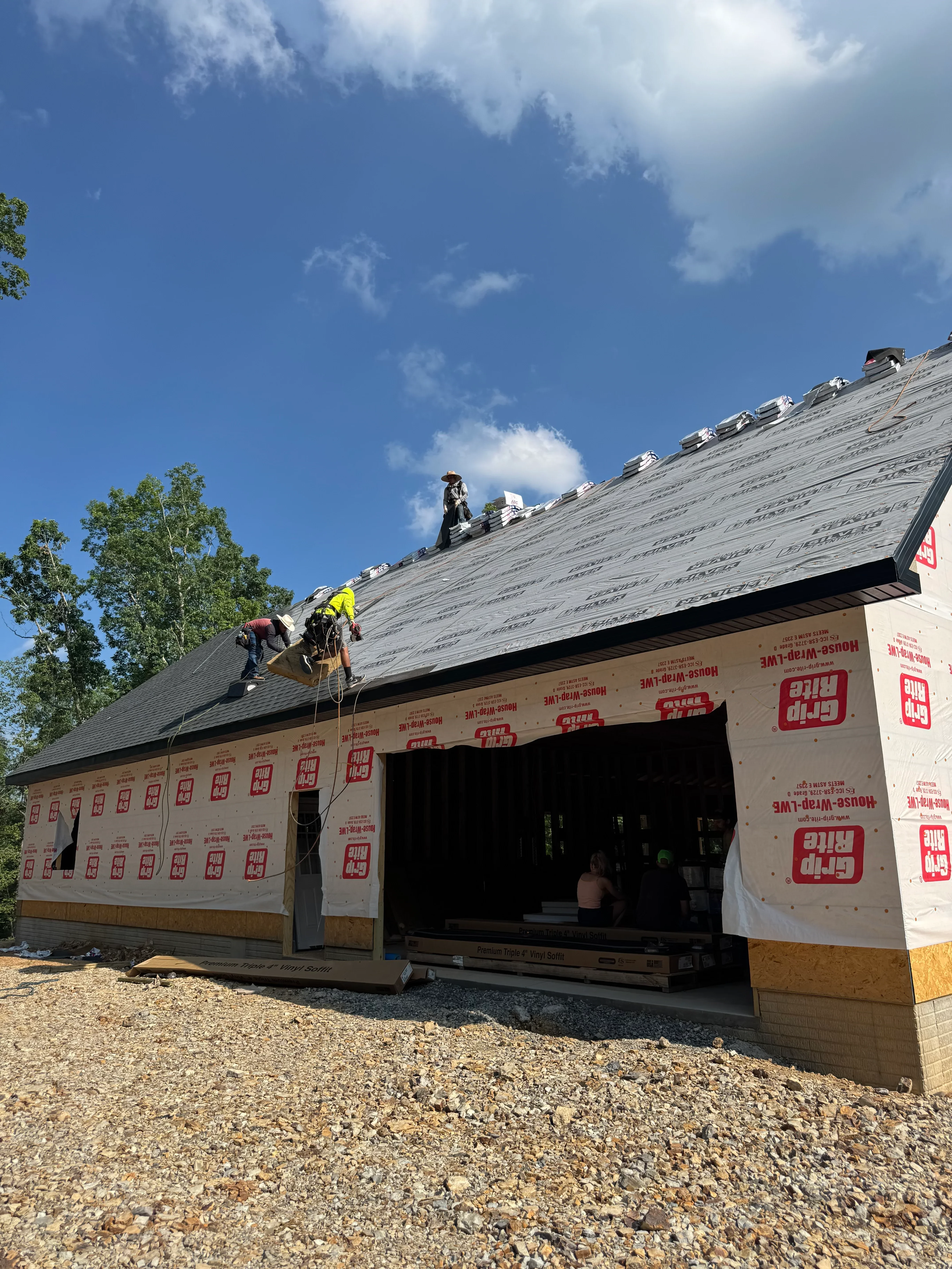 Roof installation with synthetic underlayment and wood framing on residential home